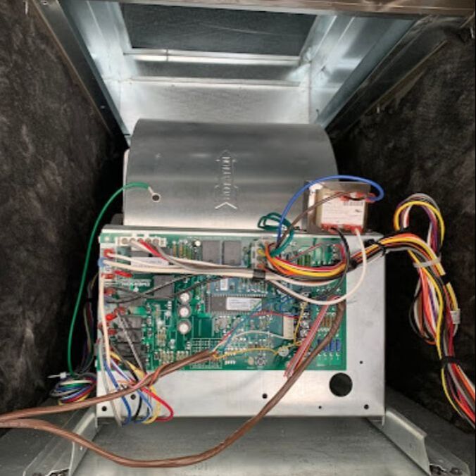 Cleaned Inside view of an air duct cleaning system showing electronic components and wiring.